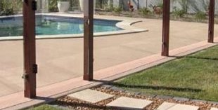 Cool way to make a modern glass pool fence less modern. You could get the glass etched with a picture or something as well (like a gumleaf) to tie it in with an existing patio fence.